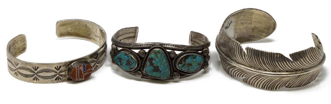 3)NATIVE AMERICAN SILVER & TURQUOISE CUFF BRACELTS: (lot of 3) Southwest Native American silver (all but one, content unknown, unmarked) cuff bracelets: (1) having central oval multi-stone and silver cabochon, worked design, signed A. Blackgoat (Arnold