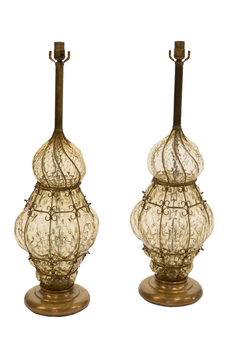 (2) MARBRO VENETIAN BALLOTON ART GLASS TABLE LAMPS: (pair) Venetian balloton art glass table lamps, blown colorless glass trapped in gilt metal caged armature, rising on circular foot, retailed by Marbro Lamp Company, approx 33.5"h, 10.5"diam; 22lbs to
