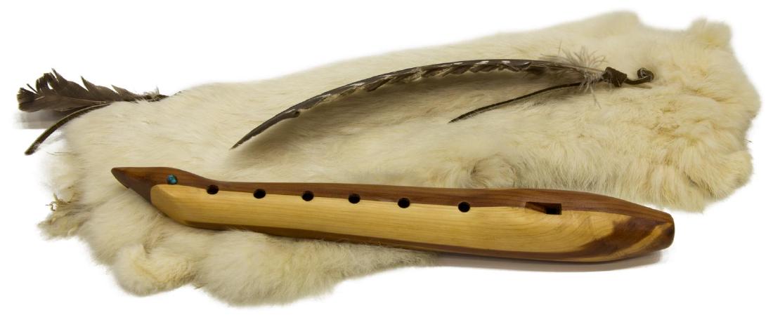 NAVAJO CEDAR FLUTE SIGNED DARRELL BEDONI: Navajo cedar six-hole "love" flute, c. 1993, signed by Darrell Bedoni, base of the flute in the form of an eagle's head, with small turquoise stone, accompanied by rabbit fur pouch and instruction boo