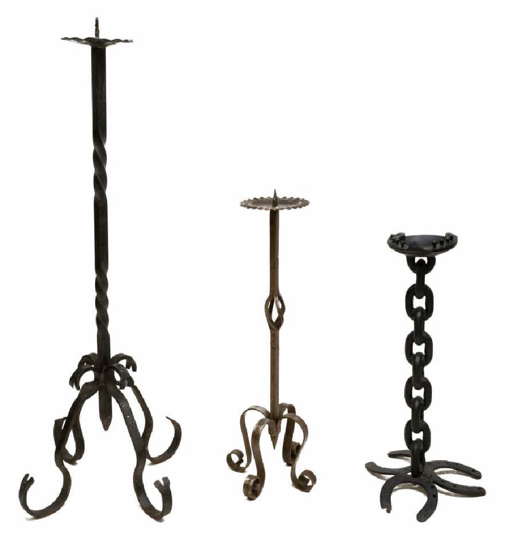 (3) VINTAGE IRON CANDLE PRICKETS & HORSESHOE STAND: (lot of 3) Iron group, comprising (2) standing candle prickets, varied design and color, one with replaced screw pricket, (1) black iron standing ashtray, horseshoe and chain motif, largest: 46" Start