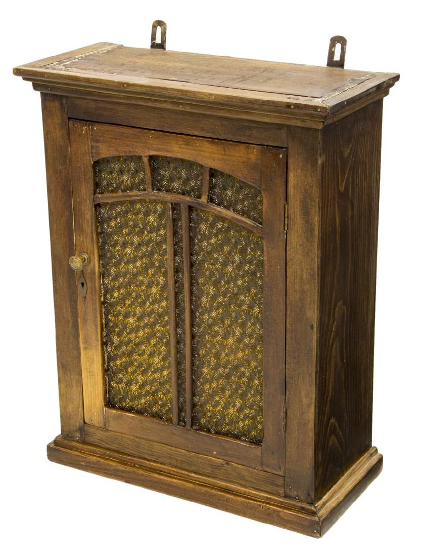 PINE HANGING MEDICINE CABINET: Pine hanging cabinet, early 20thc., having cornice top, over single-door cabinet, cabinet door with amber pressed glass panes, opening to shelves, wall-mounting hardware to back, approx 23.5"h, 18.5"w