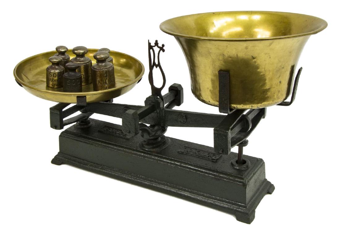 LARGE FORCE 10 KILOS IRON BALANCE SCALE: Large Continental iron balance scale, "Force, 10 kilos", with brass pans and six graduated weights, approx 15.25"h, 26"w, 12"d, 36.75lbs Start Price: $50.00