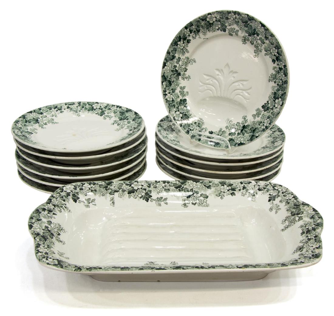 (13) SARREGUEMINES 'RECAMIER' ASPARAGUS SERVICE: (lot of 13) French Sarreguemines "Recamier" asparagus service, late 19th c., with green transfer floral border, marked underfoot, including: (1) serving cradle, 2.75"h, 16"l, 9.25"w, (12) plates with 