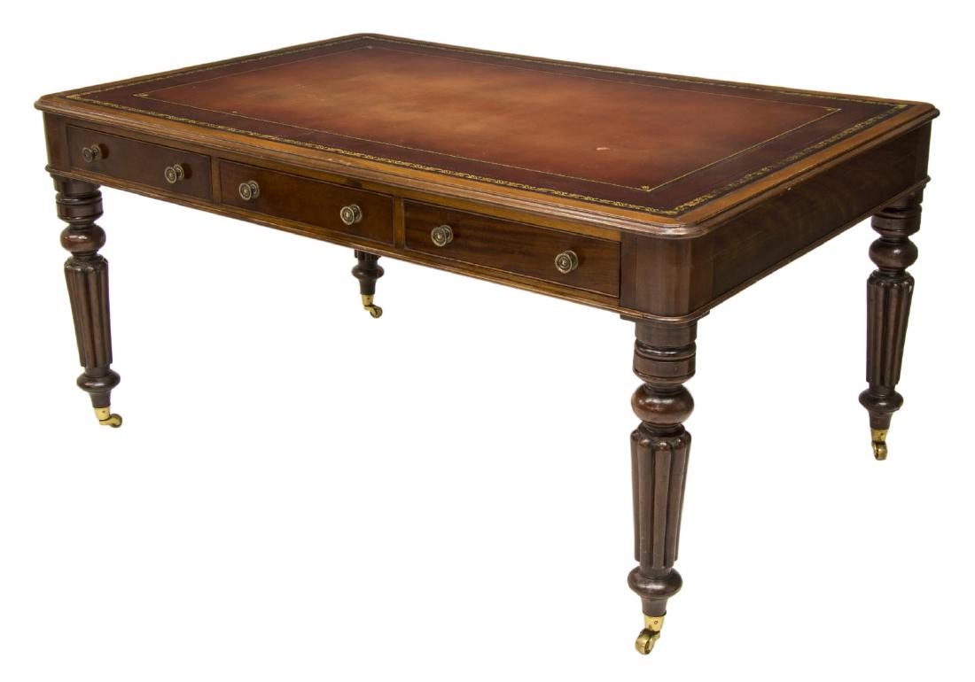 VICTORIAN MAHOGANY SIX DRAWER PARTNERS DESK: Victorian style partners desk, having a rectangular top with gilt accented inset leather over three drawers at each side, rising on tapered ribbed legs with turned feet on castors, loss to leather sur