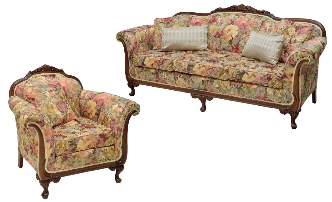 (2) CARVED MAHOGANY UPHOLSTERED SOFA & ARMCHAIR: (lot of 2) Carved mahogany sofa and armchair, in polychrome floral upholstery, having scrolled acanthus crest over bolster arms, rising on club foot cabriole legs, including: (1) sofa, having three re