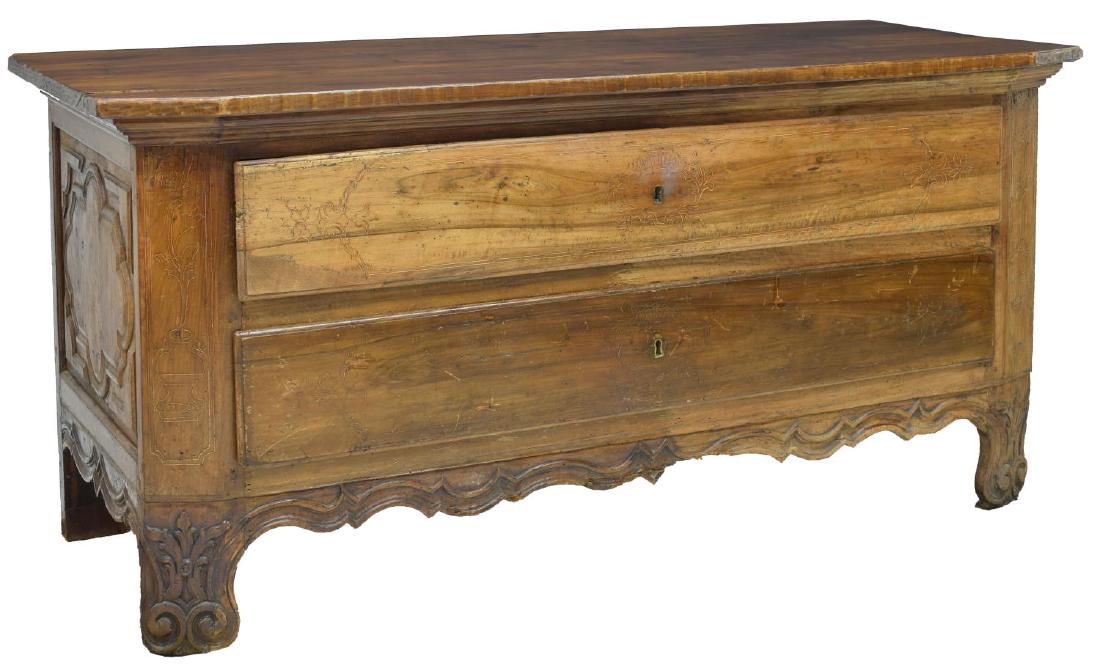 FRENCH LOUIS XIV LOW CHEST, MID 18TH C.: French Louis XIV fruitwood low chest, mid 18th c., the later rectangular top over two long drawers accented with incised foliate carving, rising on volute like supports with floral and vase carving, r