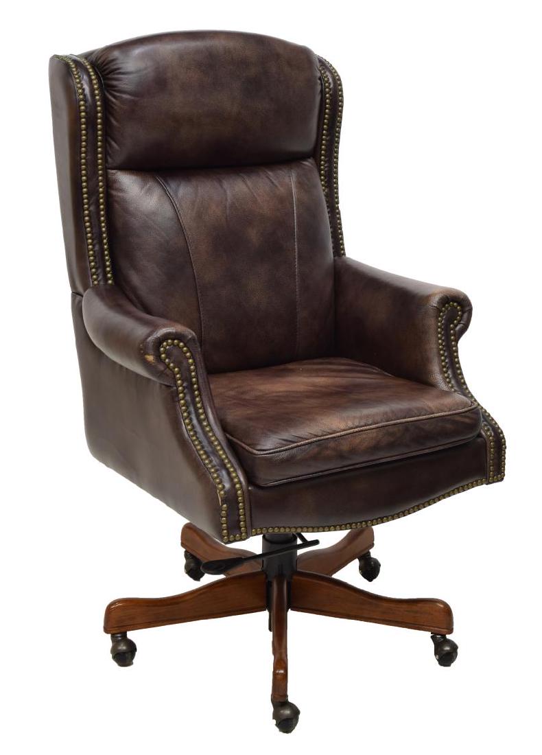 SEVEN SEAS SEATING 'EDISON' EXECUTIVE OFFICE CHAIR: Seven Seas Seating "Edison" executive office chair, having brown grained leather back and seat, with decorative brass tack trim, over swivel and tilt base, on casters, some wear to leather, approx 48"