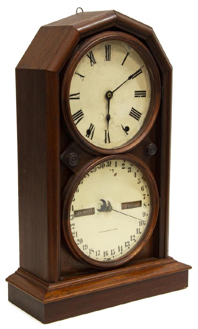 SETH THOMAS PARLOR NO. 5 CALENDAR CLOCK: Seth Thomas walnut cased Parlor Calendar No. 5 clock: eight day movement, the upper dial with Roman numerals, time and strike, the lower dial with calendar, both dials with paint loss, time observed o