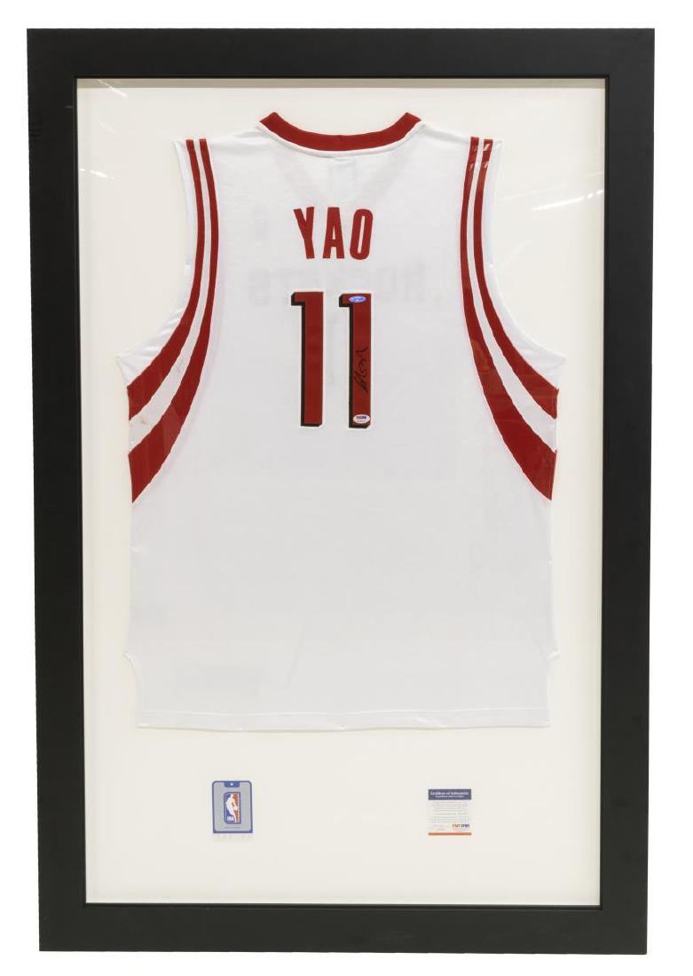 FRAMED YAO MING SIGNED HOUSTON ROCKETS NBA JERSEY: Framed Houston Rockets basketball jersey, #11, autographed by Yao Ming (China, b.1980), overall: approx 55"h, 37"w, 20lbs Start Price: $100.00