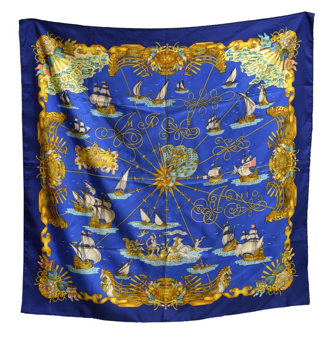 HERMES SILK TWILL SCARF, VOILES DE LUMIERE PATTERN: Hermes silk twill scarf, "Voiles de Lumiere" pattern, original design by Joachim Metz, with blue border, central prints with grand ships, retaining care tag, measurements for shipping purposes only - 