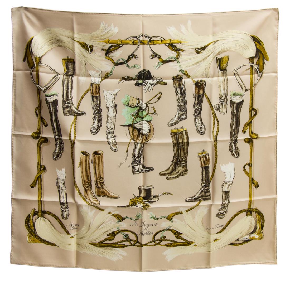 HERMES SILK TWILL SCARF, 'A PROPOS DE BOTTES': Hermes silk twill scarf, "A Propos de Bottes" pattern, original design by Xavier De Poret, pale champagne ground, with equestrian boot print, retaining care tag, accompanied by branded box, measuremen