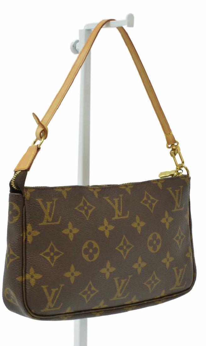 LOUIS VUITTON MONOGRAM CANVAS ACCESSORY POUCH: Louis Vuitton accessory pouch, in brown and tan monogram coated canvas, with brass hardware, tan vachetta leather trim, optional leather strap, brown canvas lining, zip closure at top, retaining dustb