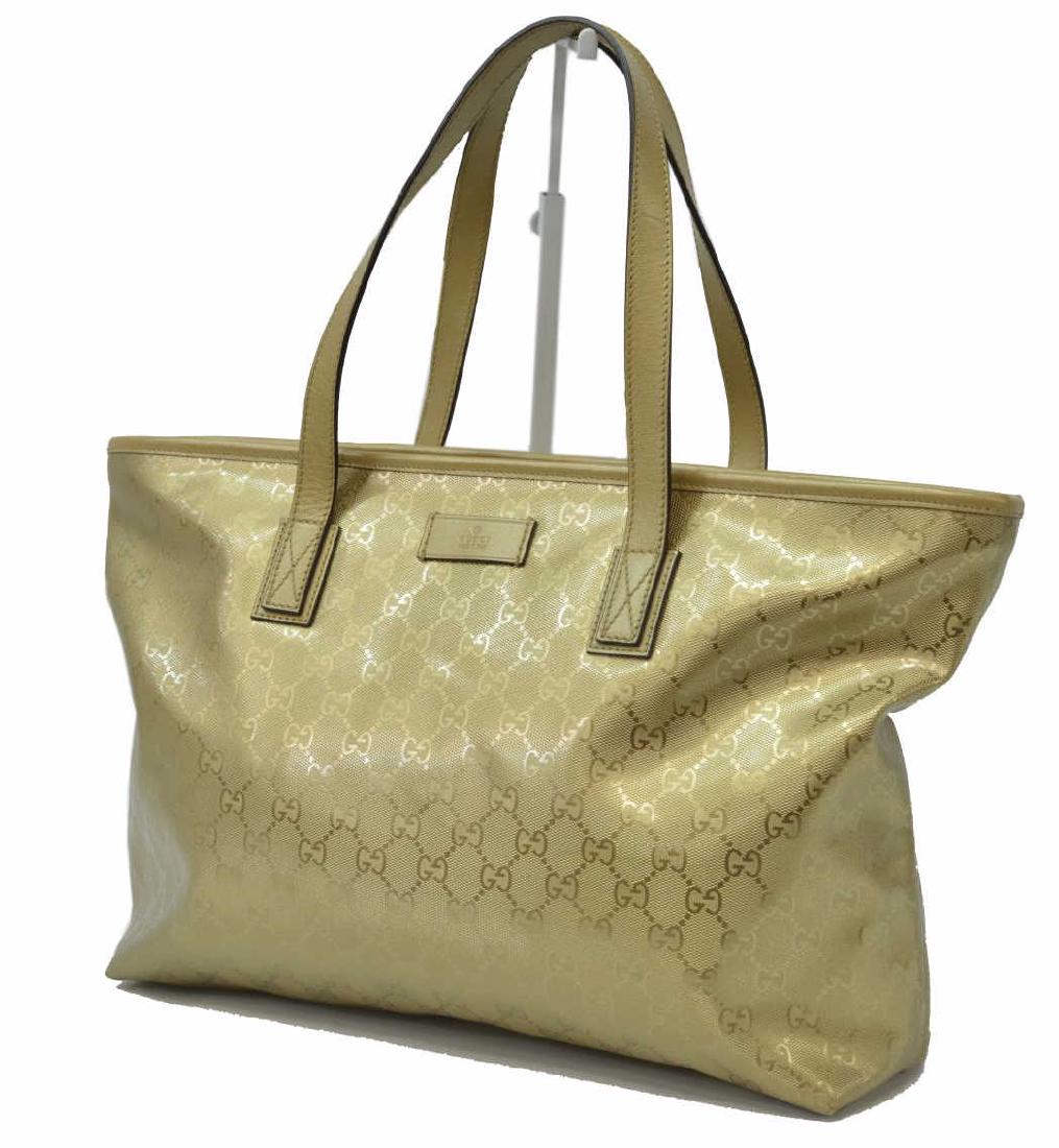 GUCCI TOTE SIZE GM METALLIC GOLD GUCCISIMA IMPRINT: Gucci tote, size GM, in metallic gold Guccisima imprint canvas, with silver-tone hardware, dual flat handles, single interior zip pocket and two slit pockets, zip closure at top, retaining dust bag, s