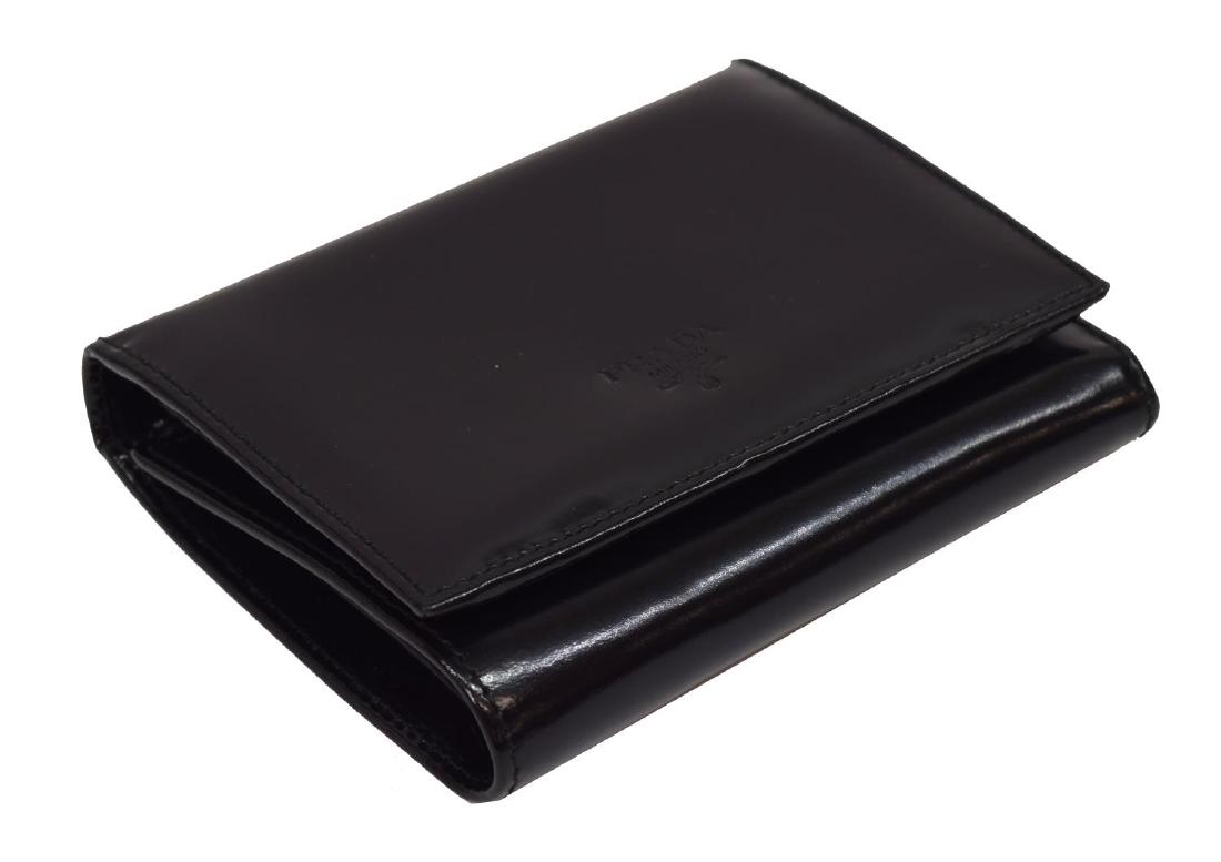 PRADA BLACK PATENT LEATHER COMPACT TRIFOLD WALLET: Prada compact trifold wallet, in black patent leather, with silver-tone hardware, six card slots at interior walls, single coin pocket with snap closure, single bill slot, snap closure at front flap,