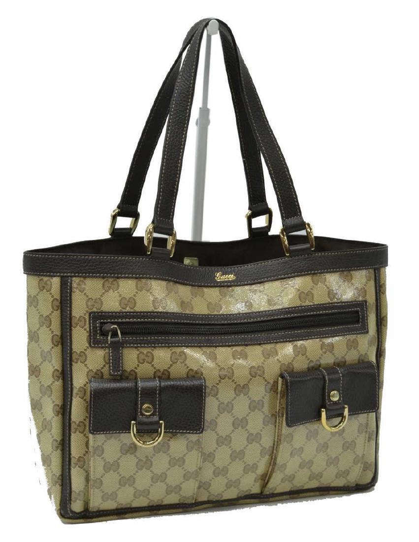 GUCCI 'ABBEY POCKET TOTE' CRYSTAL MONOGRAM CANVAS: Gucci "Abbey Pocket Toteâ€, in beige crystal monogram canvas, with gold-tone hardware, leather trim, dual flat handles, brown woven lining, single exterior zip pocket and two pockets with snap clos