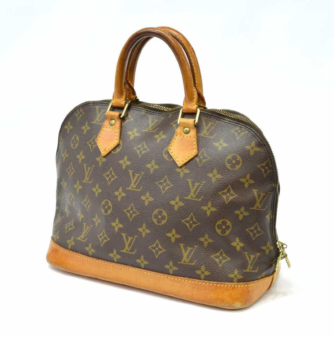 LOUIS VUITTON 'ALMA' MONOGRAM CANVAS HANDBAG: Louis Vuitton â€œAlma PMâ€ handbag, in brown and tan monogram coated canvas, with brass hardware, tan vachetta leather trim, dual rolled handles, brown canvas lining, zip closure at top, dark p