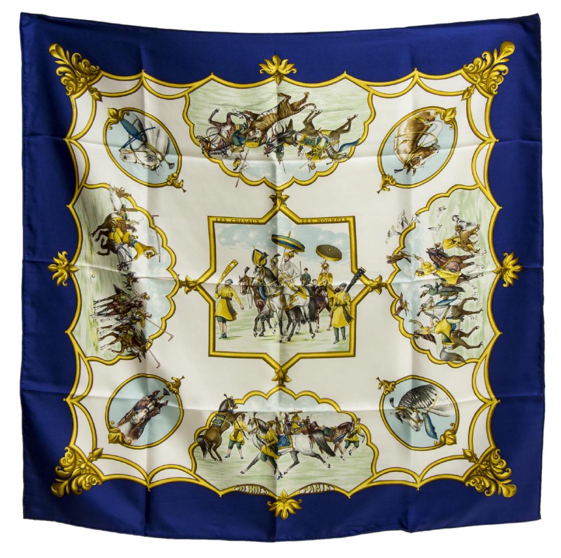 HERMES SILK TWILL SCARF, 'LES CHEVAUX DE MOGHOLS': Hermes silk twill scarf, "Les Chevaux de Moghols" pattern, original design by Jean De Fougerolle, with blue border, center ivory ground, with print of riders on horseback, retaining care tag, accompan
