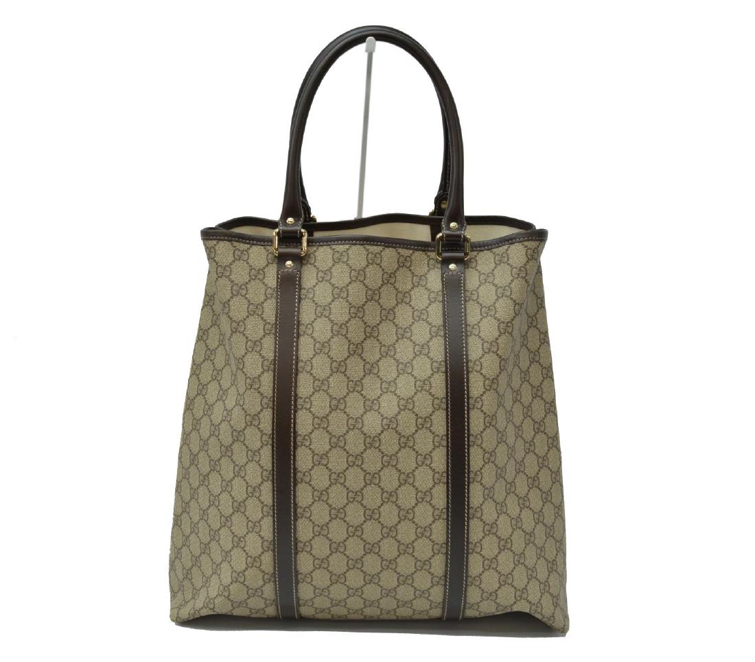 GUCCI TALL TOTE COATED CANVAS: Gucci tall tote, in coated canvas, with gold-tone hardware, leather trim, dual rolled handles, central interior zip pocket, single slit pocket, creasing and wear to leather, interior spotting, bag: me