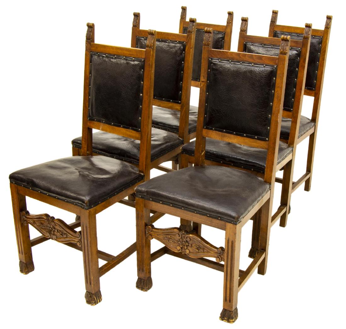 6) ITALIAN RENAISSANCE REVIVAL LEATHER SIDE CHAIRS: (lot of 6) Italian Renaissance Revival leather side chairs, early 20th c., foliated ears over leather clad back and seat, rising on a carved stretcher base, ending in paw feet, one with large hole to 