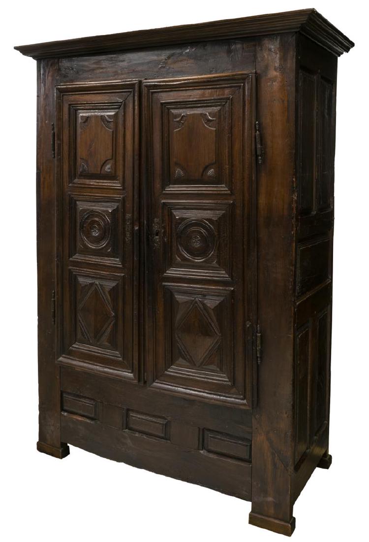 FRENCH LOUIS XIII STYLE OAK ARMOIRE: French Louis XIII style oak armoire, 19th c., stepped cornice giving way to double doors, having shaped escutcheons, carved with birds, geometric shapes, shells and rosettes, interior fitted with two