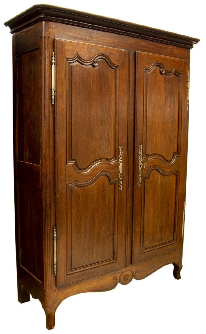 FRENCH LOUIS XVI PERIOD OAK ARMOIRE: French Louis XVI period armoire, c. 1780, having a stepped cornice over two paneled doors with ornate lock plates, all rising on cabriole legs, 86.75"h, 63"w, 24"d Start Price: $300.00