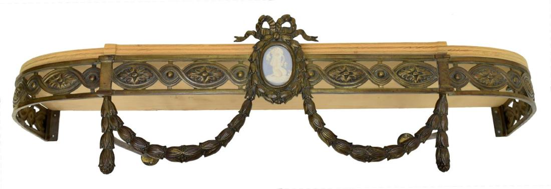 LOUIS XVI STYLE CANOPY BED CROWN, PLAQUE: Louis XVI style brass canopy bed crown, 19th c., a ribbon crest over the blue and white wreath framed bisque plaque depicting a youthful satyr, the flanking frame with pierced circular and oval decora