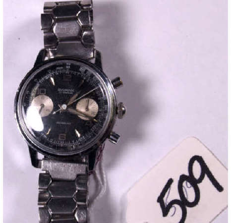 TW0 SWISS MADE MULTI-DIAL CHRONOGRAPH WATCHES: Two chronograph wrist watches. #509 A Swank, Swiss, 17J, black dial marked Incabloc, stainless case & band. #542 A Rego chronograph, Swiss made, black dial, luminescent numbers. Both watches observed