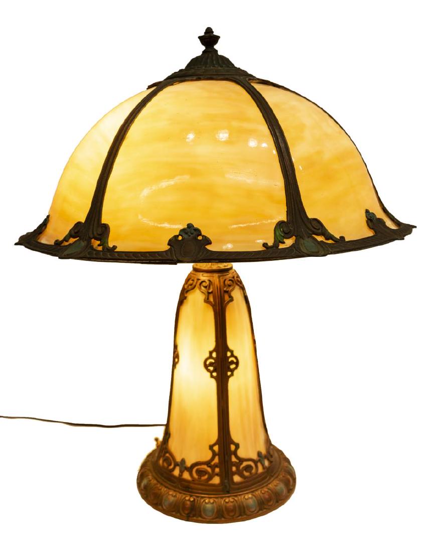 AMERICAN SLAG GLASS & PATINATED METAL TABLE LAMP: American slag glass and patinated metal table lamp, early 20th c., the domed slag glass shade in cream and tan tones, having gilt metal overlay, concealing two light sockets with two pull chains, over