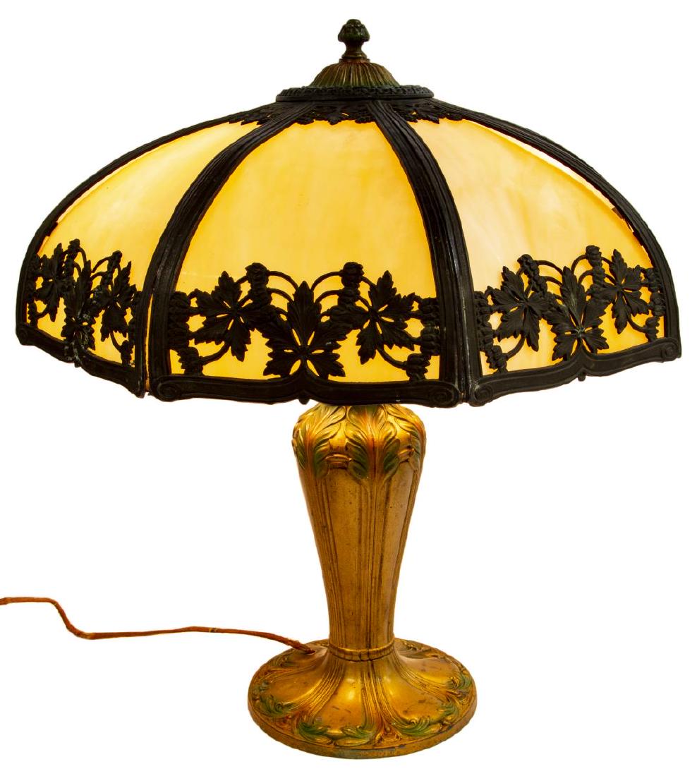 AMERICAN SLAG GLASS & GILT METAL TABLE LAMP: American Art Nouveau slag glass table lamp, early 20thc., the domed shade with leafy openwork metal frame, over dual light sockets, on a gold painted base with polychrome foliate accents, wiring very 