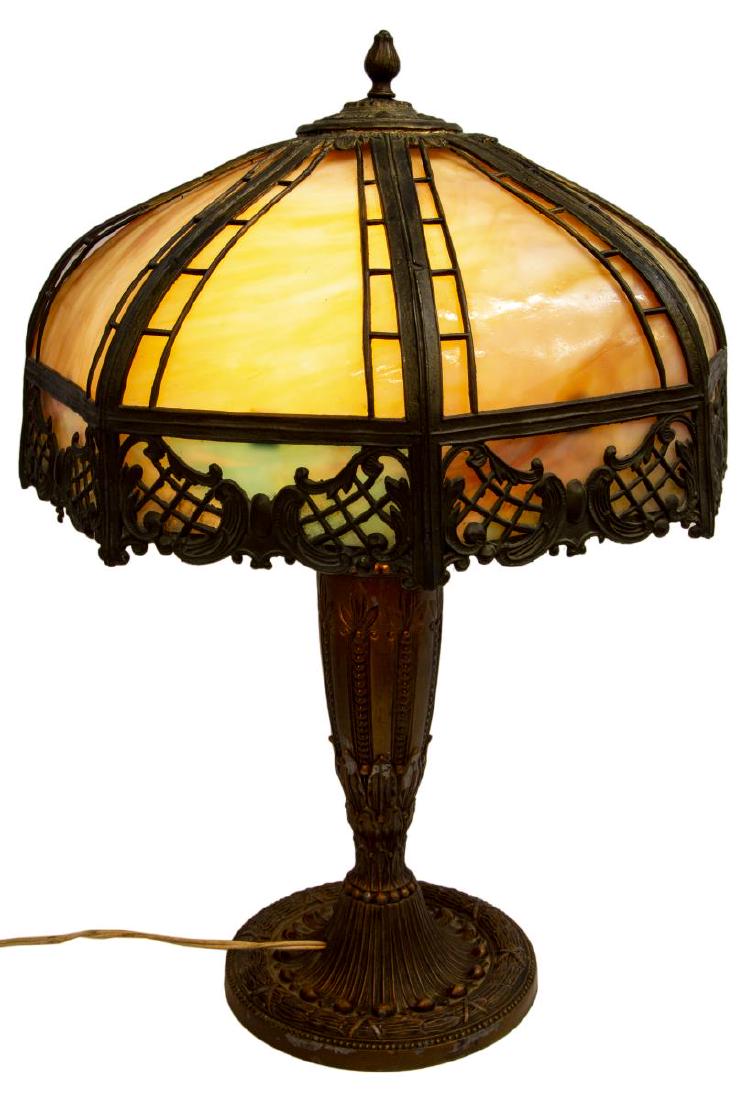 AMERICAN SLAG GLASS & GILT METAL TABLE LAMP: American slag glass table lamp, early 20thc., the domed lattice and openwork metal framed shade with caramel and other colored slag glass inserts, two light sockets, on a foliated and laurel wreath tr