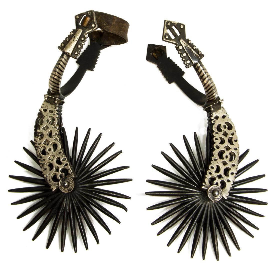 (PAIR) FANCY SOUTH AMERICAN SPURS, 5.75" ROWELS: (pair) Fancy Chilean Huaso cowboy spurs, c. 1900, the heel with shaped and inset nickel silver, the shank faced with pierced nickel silver extending to the 28 point 5.75" diameter rowels, three rowel 