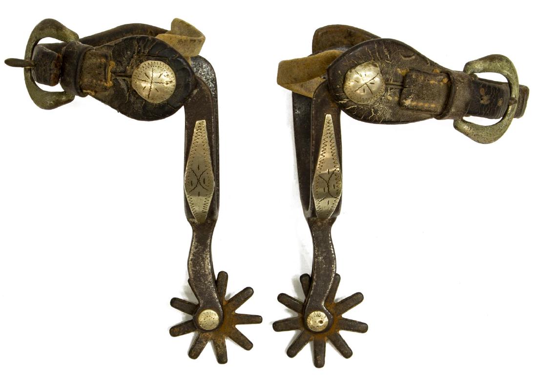 CROCKETT COWBOY, 1930'S: (pair) Crockett cowboy spurs, 1930's, marked at outside, mounted nickel silver on leathers button, outside heel and shank, 9 point, 1.5/8" diameter rowels, inside yoke: approx. 3.1/8"w, 3"d, total: 1l