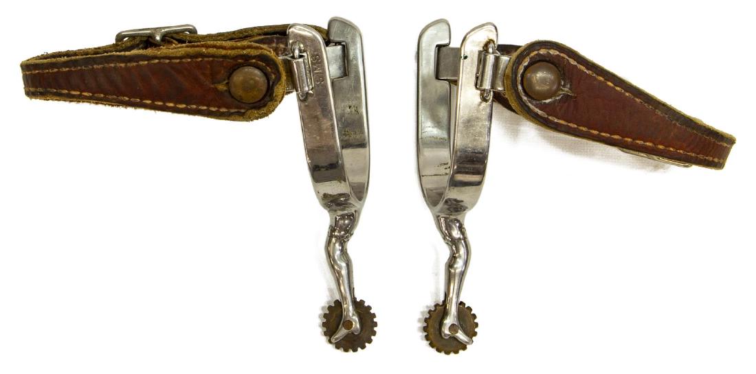 ED SIMS, UVALDE, TEXAS GAL LEG SPURS: (pair) Cowboy gal leg spurs signed Sims (Ed Sims, Uvalde, Texas), nickel plated, 18 point 1" diameter rowels, buckled leathers, inside yoke: 3.3/8"w, 3.1/8"d, total: 1lb Start Price: $80.00