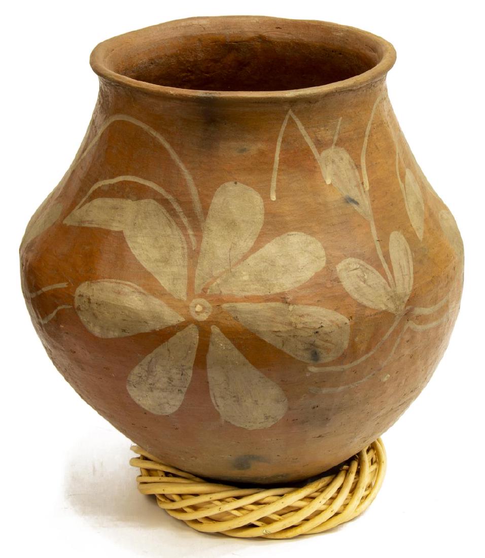 LARGE MEXICAN REDWARE POTTERY OLLA: Large redware pottery olla, Mexico, with painted floral motif, accompanied by wicker wreath stand, approx 15"h, 15.5"diam, 16lbs Start Price: $50.00