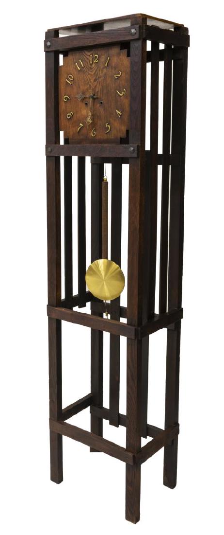 MISSION OAK TALL CASE CLOCK, WATERBURY MOVEMENT: American Mission style standing clock, with slatted oak tall case, oak clock face, with brass finished numerals, time and strike movement, movement marked Waterbury Clock Co., retaining keys and pendu