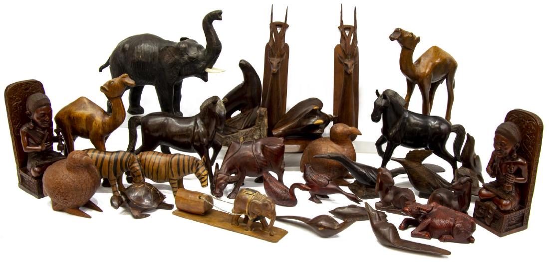 (LOT) LARGE GROUP OF CARVED WOOD FIGURES & ANIMALS: (lot) Large collection of carved wood figures and animals, highlights include: (1) leather-clad elephant, 11.75"h, 14"w, 4.5"d, (2) carved wood camels, with bead eyes, 11"h, 9.5"w, 3"d, (2) carved woo