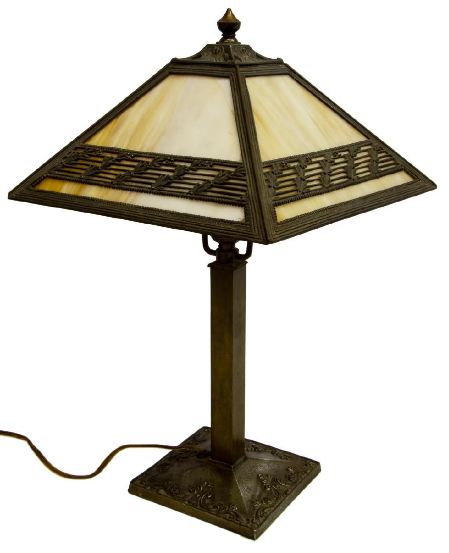 AMERICAN SLAG GLASS & FOLIATED METAL TABLE LAMP: American slag glass table lamp, caramel glass held by a metal frame with berry vines and beading, single light, on a squared standard, cast foot with trailing foliates and remnants of gilding, approx 