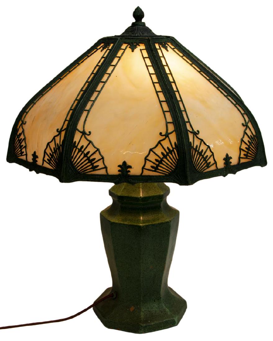 VINTAGE SLAG GLASS & GLAZED CERAMIC TABLE LAMP: Vintage slag glass table lamp, having a paneled ceramic (terracotta?) base in a verde finish, two light sockets, beneath the verde metal shade with some loss to trim, inset slag glass panels, some gla