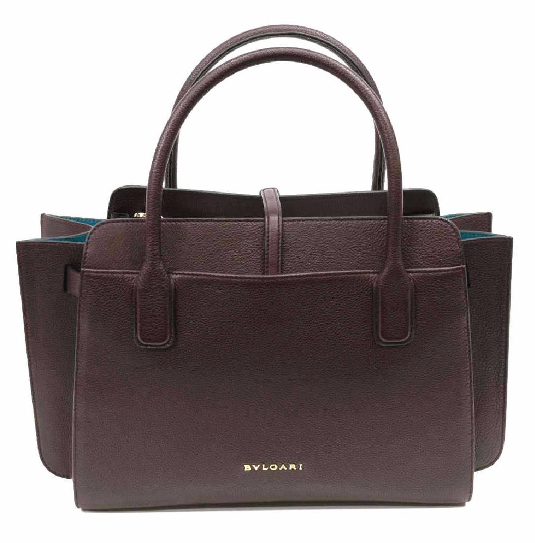 BULGARI LOGO PLAQUE TOTE PM PLUM GRAINED LEATHER: Bulgari logo plaque tote, size PM, in plum grained leather, with gold-tone hardware, dual rolled handles at top, blue-tone lining, dual exterior slit pockets, dual interior slit pockets, single interi