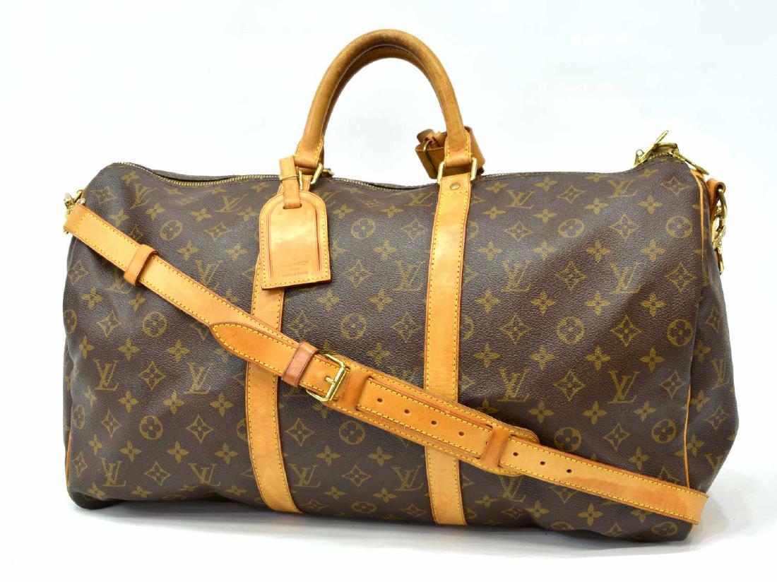 LOUIS VUITTON 'BANDOULIERE 50' MONOGRAM CANVAS: Louis Vuitton "Keepall Bandouliere 50â€ duffle bag, in brown and tan monogram coated canvas, with brass hardware, tan vachetta leather trim, detachable flat shoulder strap, dual rolled handles, bro