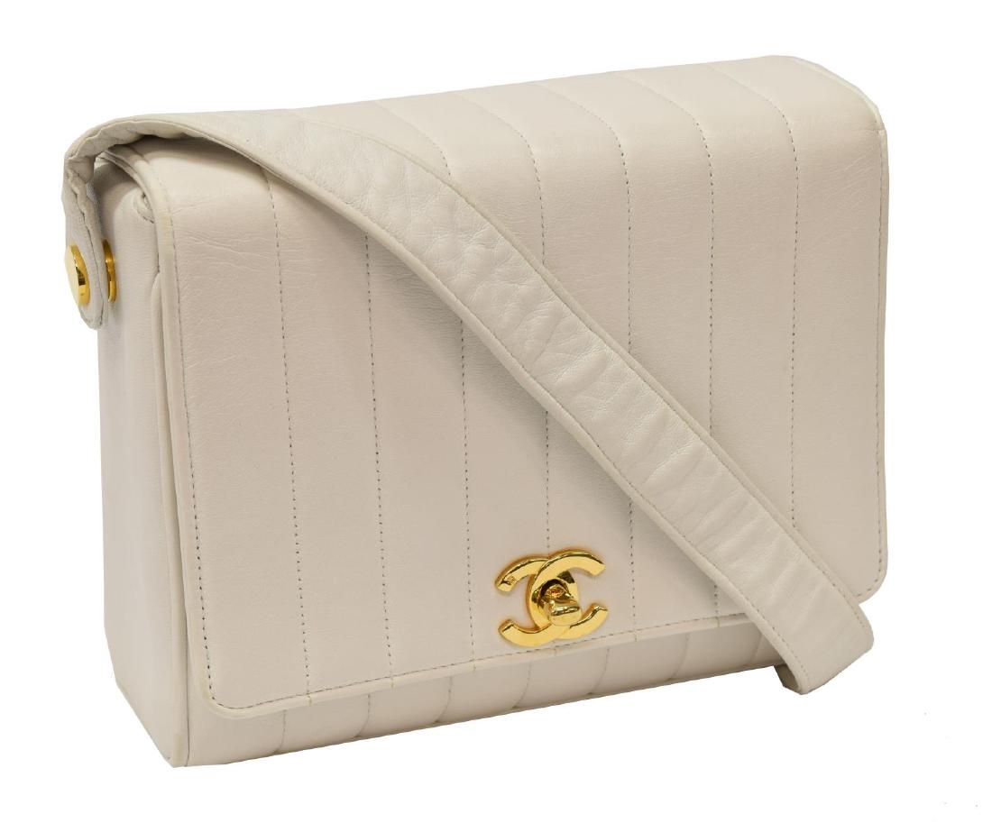 CHANEL QUILTED LEATHER SQUARE BOX HANDBAG: Chanel square box handbag, in white vertical quilted leather, with gold-tone hardware, single flat top shoulder strap, exterior slip pocket at back, tonal leather lined interior with slip and zipper p