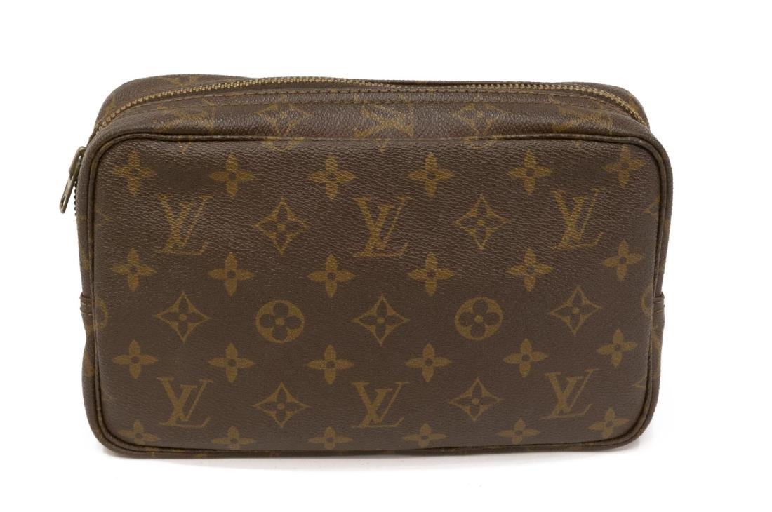 LOUIS VUITTON TOILETRY POUCH MONOGRAM CANVAS: Louis Vuitton toiletry and cosmetic pouch, in brown and tan monogram coated canvas, with brass hardware, beige coated lining, pocket and elasticized straps at interior walls, zip closure at top, spott