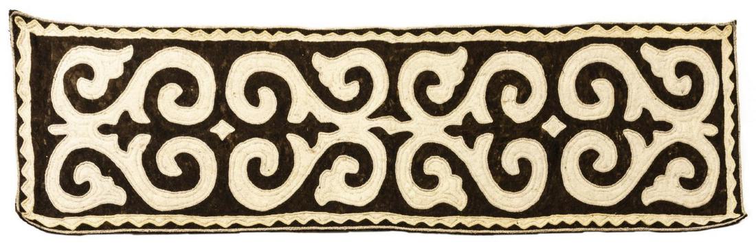 SHYRDAK FELT RUNNER, CENTRAL ASIA 9'1 X 2'6.75": Shyrdak felt runner, Central Asia, stylized heart forms (symbolizing hospitality) on a brown ground, , approx 9'1, 2' 6.75" Start Price: $150.00