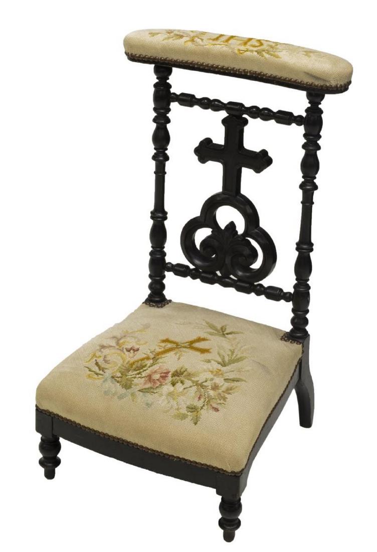 FRENCH NAPOLEON III PRAYER CHAIR: French Napoleon III prayer chair, c. 1870, the ebonized wood frame with carved cross finished with needlepoint upholstery depicting flowers, a cross and the Christian monogram IHS, raised on turned fr