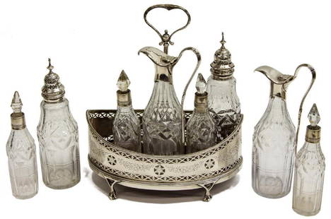 ENGLISH HESTER BATEMAN STERLING SILVER CRUET SET: English Georgian sterling silver and glass cruet set, Hester Bateman (United Kingdom, 1708-1794), late 18th c. (date letter partially obliterated), reticulated stand, with center handle ending in Geor