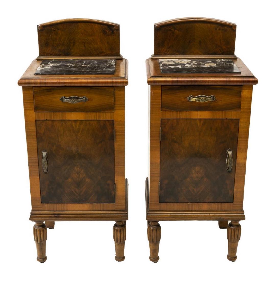 (2) ITALIAN BURLWOOD MARBLE TOP NIGHTSTANDS: (pair) Italian burlwood nightstands, 20thc., each having short splash over inset marble top, case fitted with a single drawer above cabinet, with interior shelving, rising on ribbed cylindrical suppor