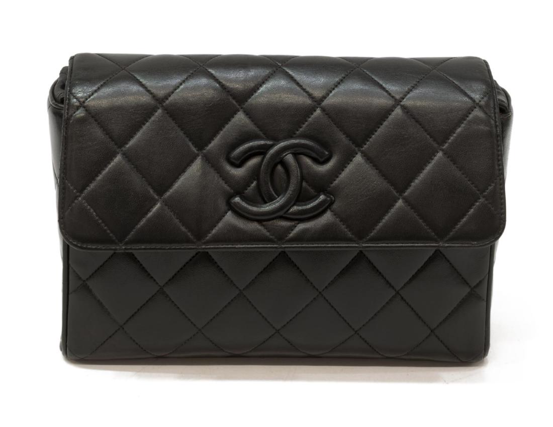 CHANEL FRONT FLAP QUILTED LEATHER SHOULDER BAG: Chanel front flap shoulder bag in black quilted leather, with gold-tone hardware, flat shoulder strap, snap closure at front, zipper pocket to red lined interior, creasing, slight scuffing to interior