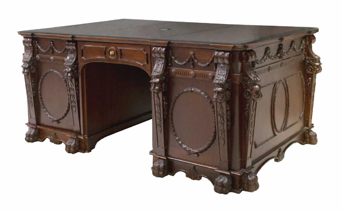 ORNATE LOUIS XVI STYLE MAHOGANY PARTNERS DESK: Mahogany Louis XVI style double pedestal partners desk, early 21st c., ornately decorated with lion mask pilasters, ribbons and garlands, three inset leather panels beneath the beveled glass top, each