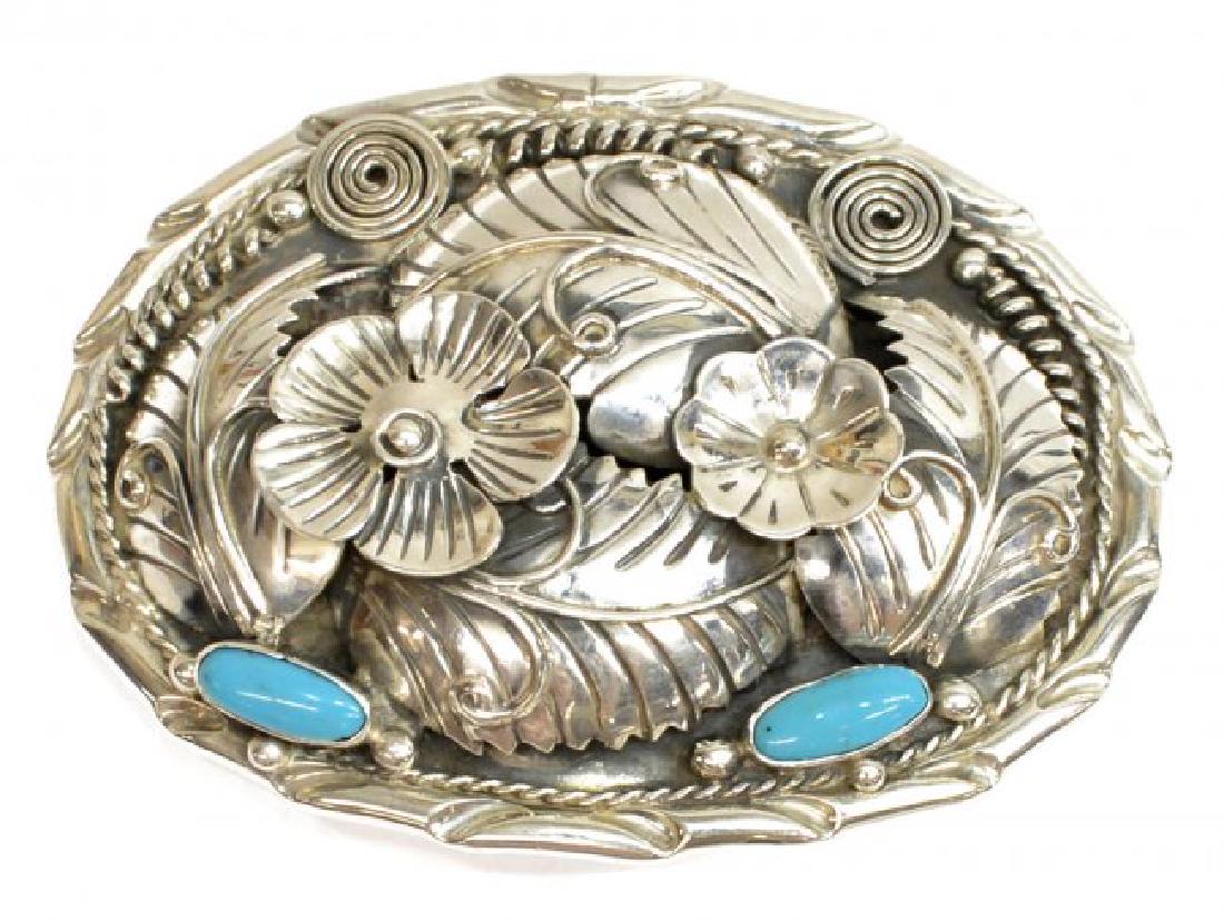 SOUTHWEST 950 SILVER TURQUOISE BELT BUCKLE, TAXCO: 950 silver belt buckle, Taxco, Mexico, feathers, flowers and tight swirls on the oval form, inset with two oval turquoise cabochons, marked 950, TA-179, Mexico on the back, 2.75"h, 3.5"w, 3.29ozt (inc