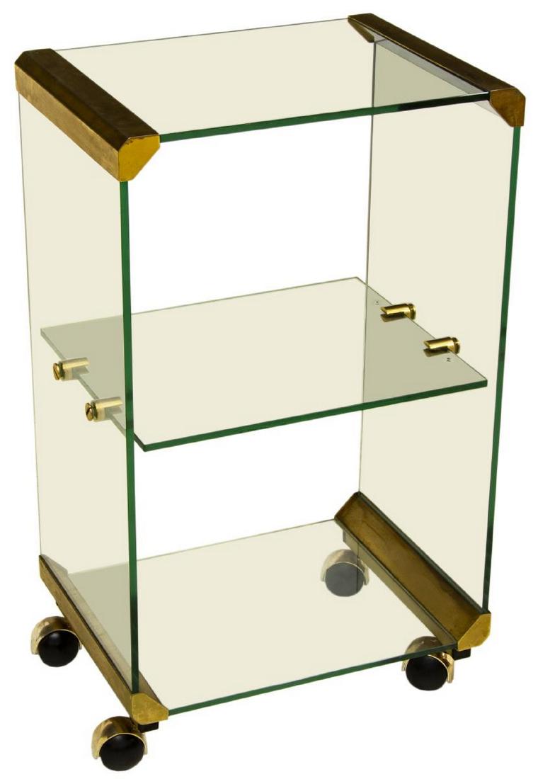 MODERN BRASS & GLASS THREE-TIER SERVICE BAR CART: Italian modern service cart, c. 1970s, having three tiers of glass shelves, glass sides, joined with brass hardware, on wheels, approx 27.25"h, 16"w, 12"d Start Price: $150.00